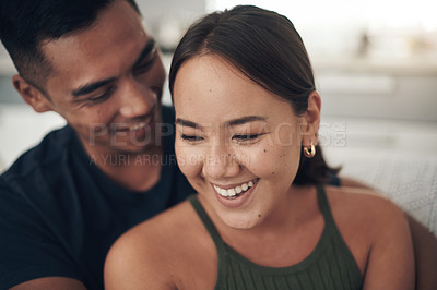 Buy stock photo Couple, hug and laugh on couch for love, humor and romance on home date and funny joke for comedy. People, happy and bonding in embrace for marriage, support and trust in connection or comfort
