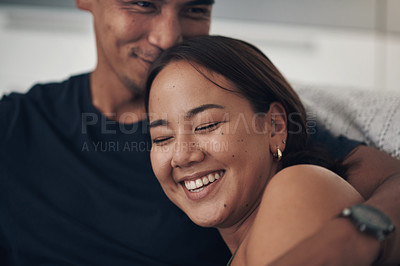 Buy stock photo Couple, hug and laugh on sofa for love, humor and romance on home date and funny joke for comedy. Happy people, relax and bonding in embrace for marriage, support and trust in connection or comfort