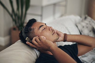 Buy stock photo Home, relax and man with headphones, listening to music and peaceful with wellness and zen. Person, apartment and guy with headset and streaming podcast with break and resting with sound and song