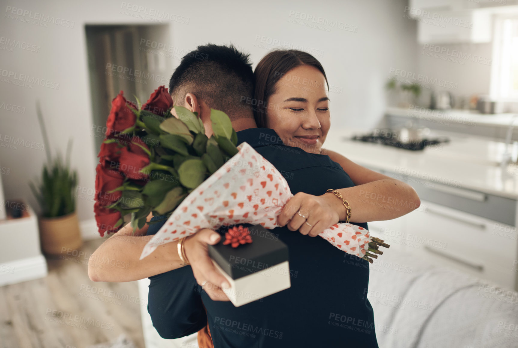 Buy stock photo Couple hug, present and roses surprise of an Asian woman with gift on valentines day. Living room, rose bouquet and lounge of people with love, care and happiness together with a smile from present