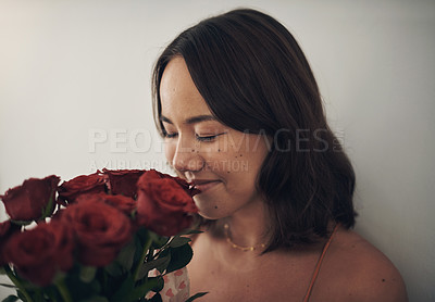 Buy stock photo Rose, love and valentines day with an asian woman smelling a gift bouquet for romance or dating. Flowers, scent and aroma with a happy young female holding red roses in romantic celebration