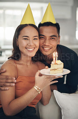 Buy stock photo Portrait, birthday and cake with a couple in their home, holding dessert for celebration in party hats. Love, candle or romance with a young man and woman celebrating together in their house