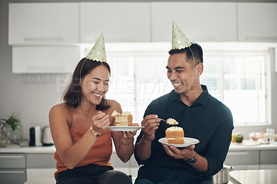 Buy stock photo Birthday, cake and couple in a kitchen for celebration, happy and bonding in their home, smile and laughing. Party, people and man with woman on a counter for eating, fun and celebrating in Japan