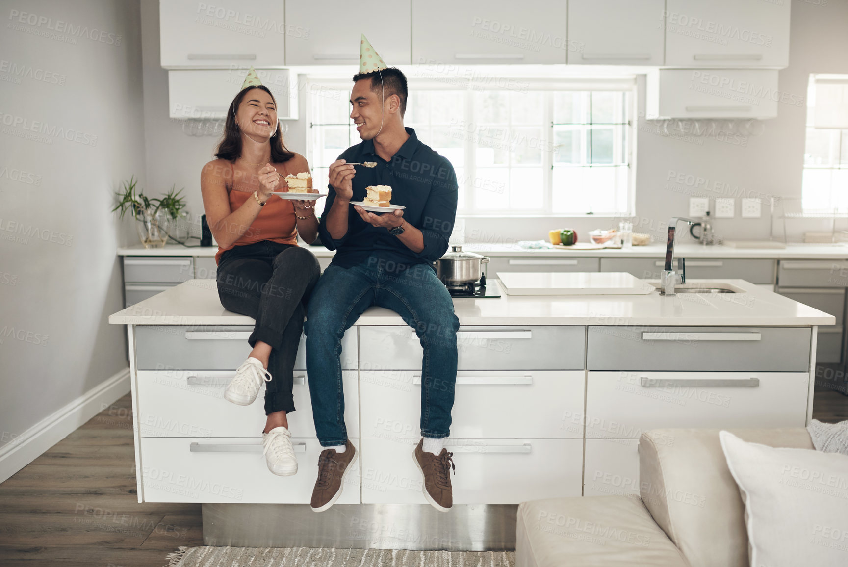 Buy stock photo Couple, birthday cake and celebration in a home kitchen with happy people and food. Celebrate, table sitting and laughing of a woman and man together with love and care with dessert for party