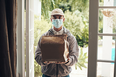 Buy stock photo Shot of a young man delivering a package to a customer at home