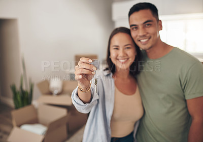 Buy stock photo Shot of a couple holding up the house key to their new home