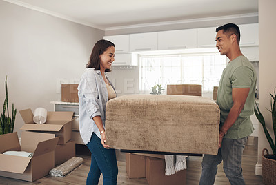 Buy stock photo Young couple, furniture and moving to new home with boxes for renovation, investment or relocation. Happy, man and woman carrying sofa for apartment, property rent and mortgage loan together