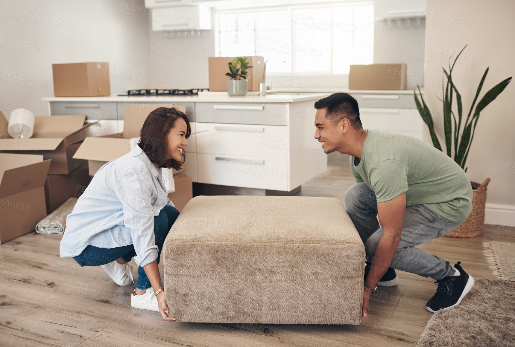 Buy stock photo Young couple, furniture and moving to new home with boxes for renovation, investment or relocation. Happy, man and woman carrying sofa for apartment interior, property rent and mortgage loan together