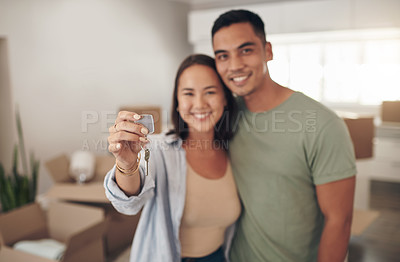 Buy stock photo Portrait, couple and smile in new home with keys for moving in, satisfied and confident with ownership. House, relationship and happy with unpacking furniture, excited and positive with property