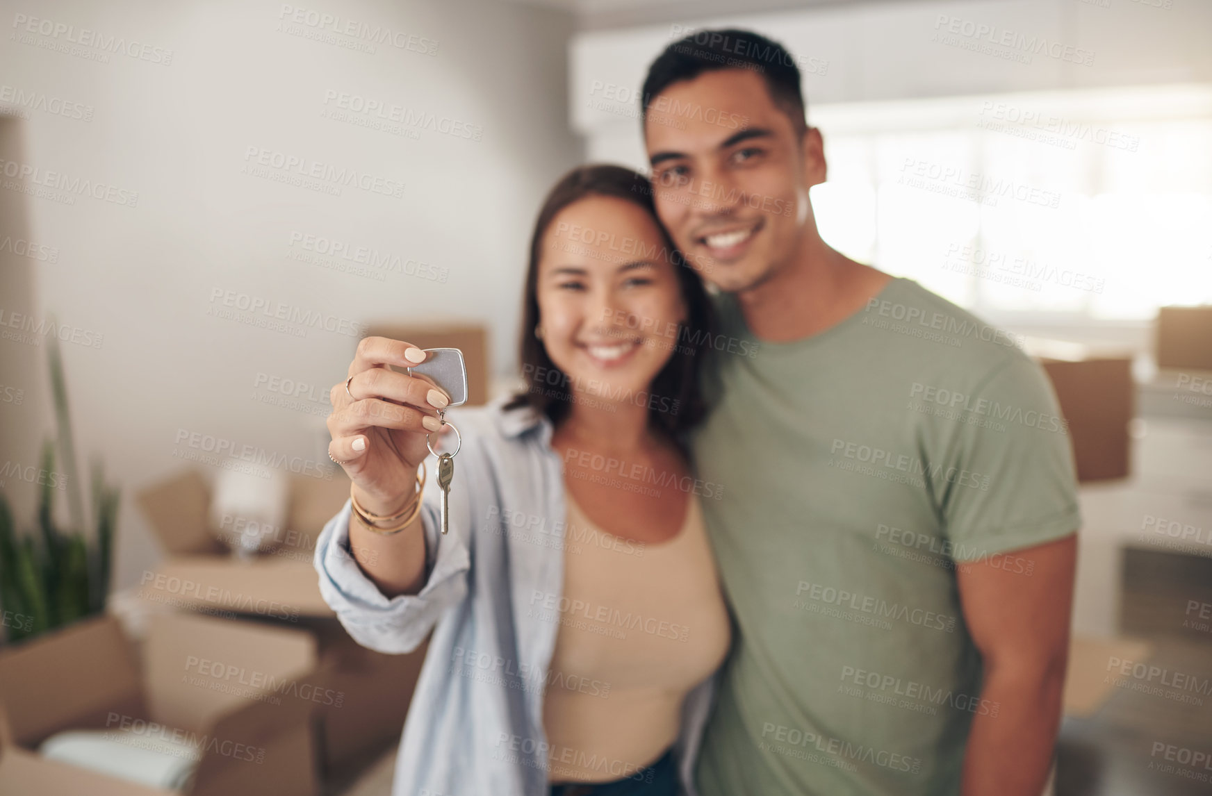 Buy stock photo Portrait, couple and smile in new home with keys for moving in, satisfied and confident with ownership. House, relationship and happy with unpacking furniture, excited and positive with property