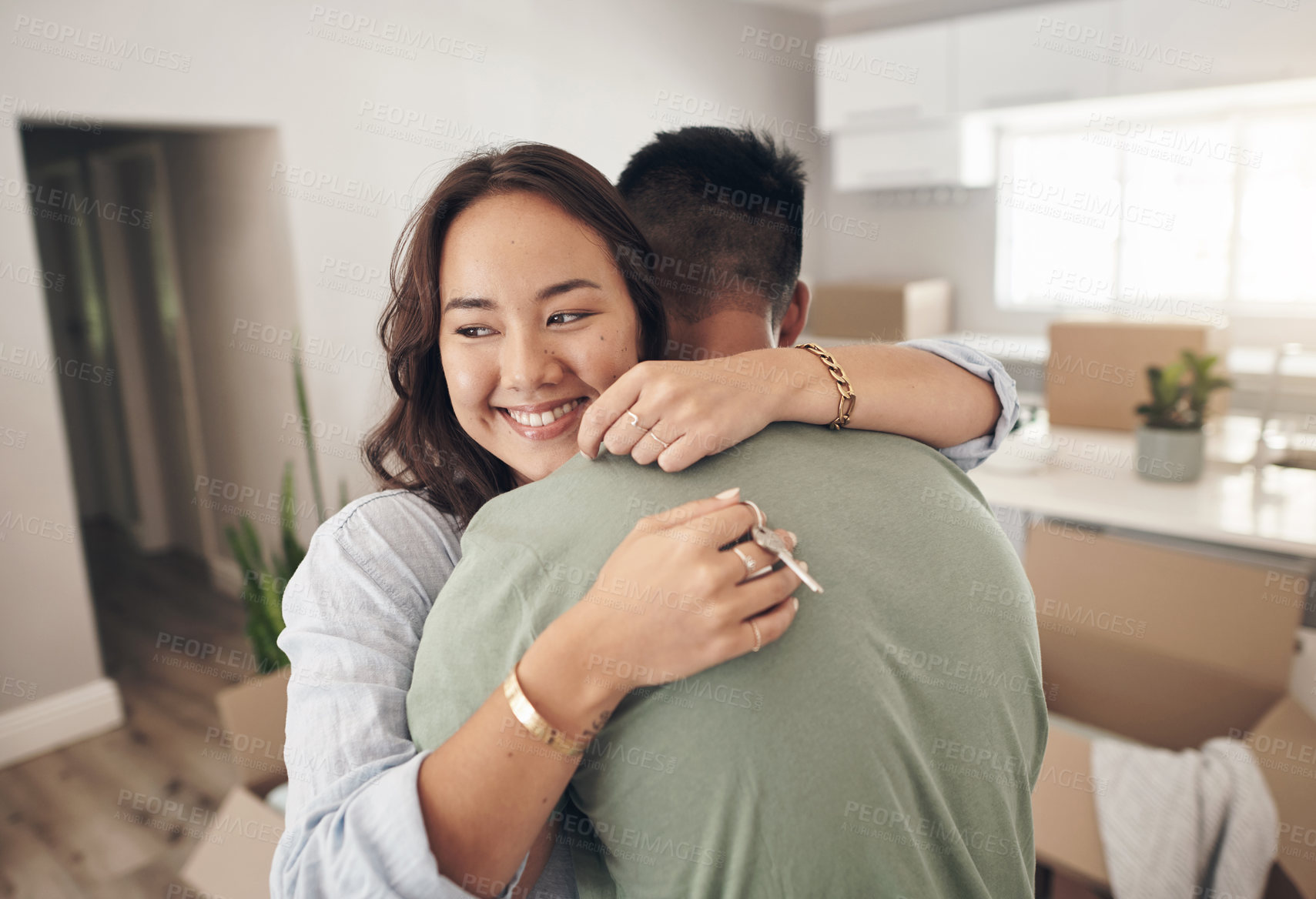Buy stock photo Hug, apartment or happy couple with home key in new house in investment, property or real estate. Boxes, mortgage or proud man with woman in lounge for achievement with loan success, goal or security