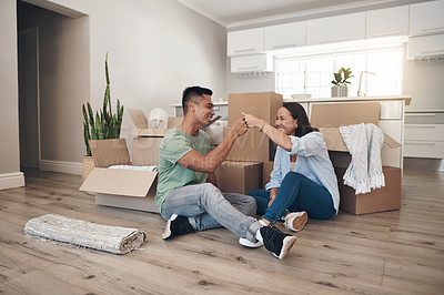 Buy stock photo Young couple, celebrate and moving to new home with boxes for renovation, investment or relocation. Happy, man and woman in living room excited for apartment together, property rent and mortgage loan