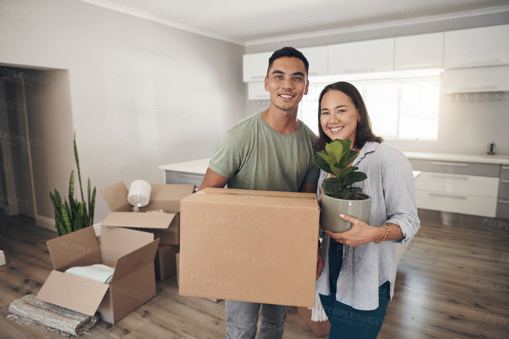 Buy stock photo Young couple, portrait and moving to new home with boxes for renovation, investment or relocation. Happy, man and woman carrying plant for apartment interior, property rent and mortgage loan together