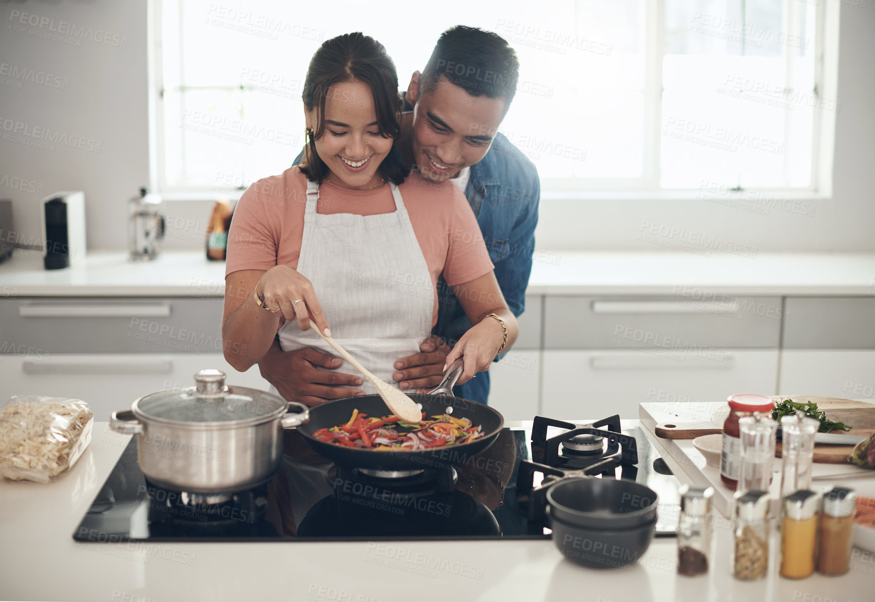 Buy stock photo Hug, cooking and happy couple in kitchen together with healthy food, relationship and bonding in home. Diet, man and woman embrace in apartment with nutrition, care and meal prep for lunch with love