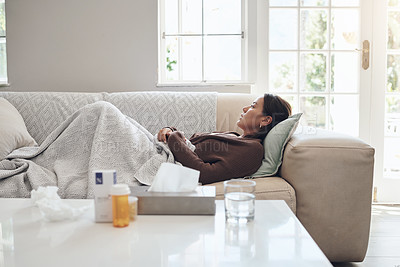 Buy stock photo Woman, couch and sad or sick in home, cold and medicine for illness and treatment for health. Female person, blanket and virus on sofa for burnout, pills and stress for crisis or pain and drugs