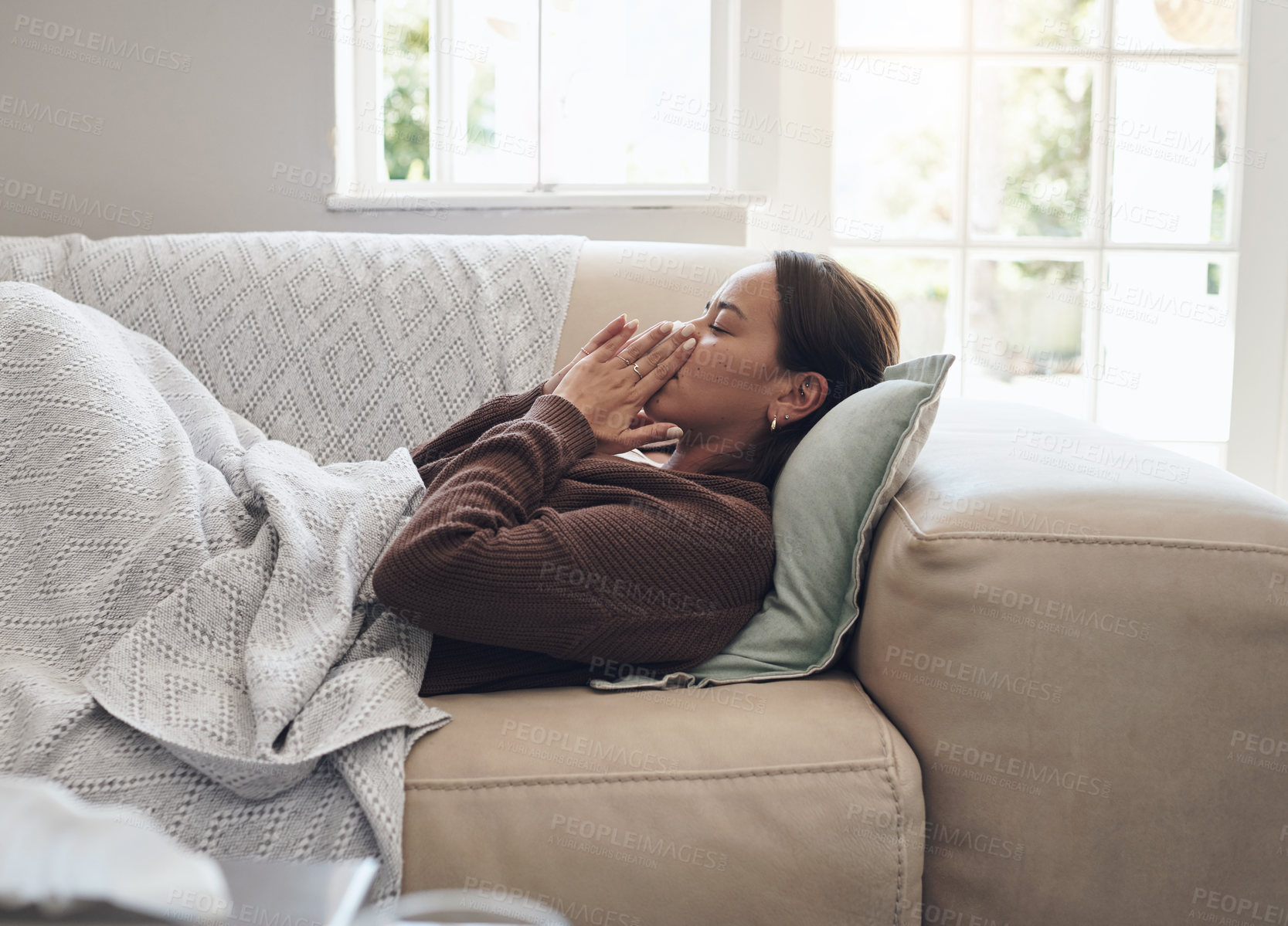 Buy stock photo Sick woman, sneeze and blowing nose with illness, flu or cold on living room sofa at home. Young female person with tissue for bacteria, fever or influenza in fatigue or rest on lounge couch at house