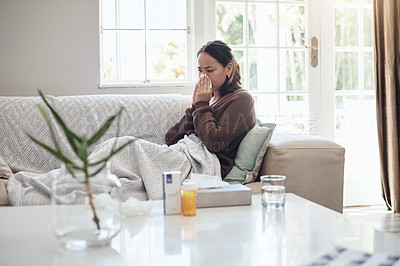 Buy stock photo Sick woman, tissue and blowing nose with flu, cold or illness on living room sofa at home. Young female person with medication for sneeze, fever or influenza from infection on lounge couch at house