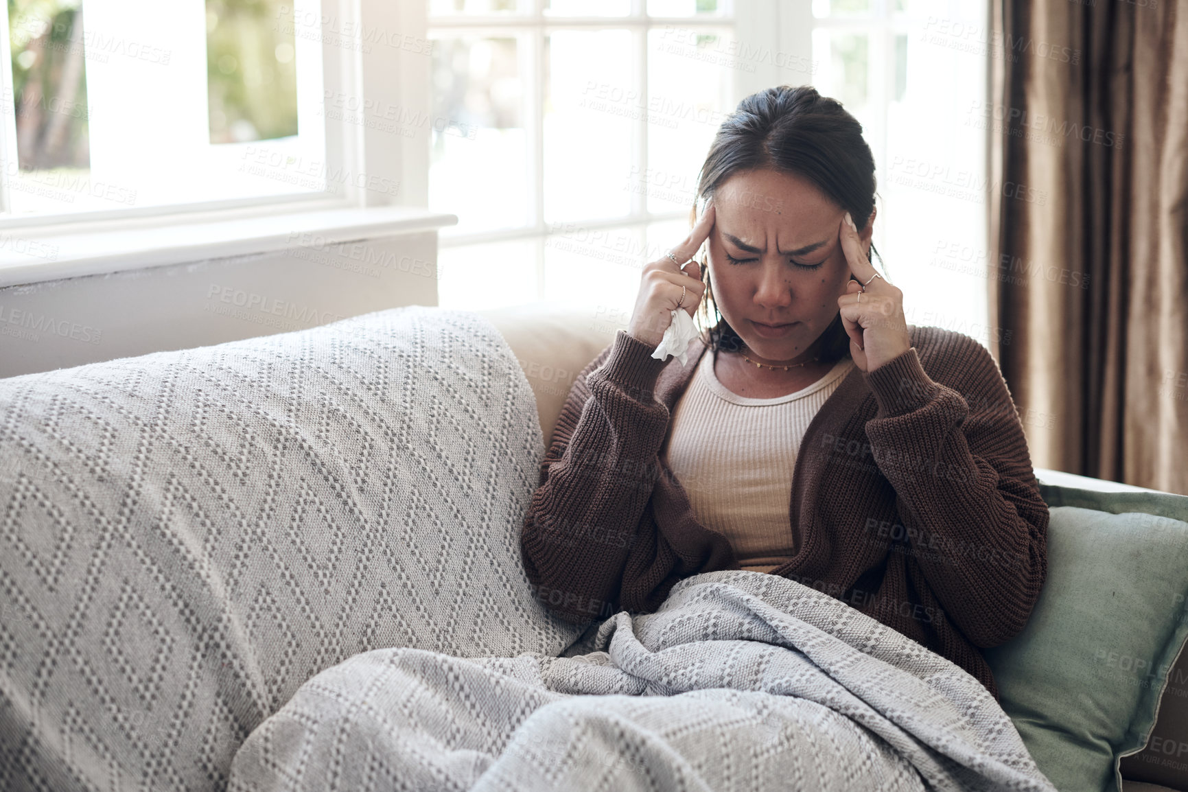 Buy stock photo Sick woman, tissue and headache with sinus, flu or pain from illness on living room sofa at home. Tired female person with migraine from high fever, influenza or infection on lounge couch at house