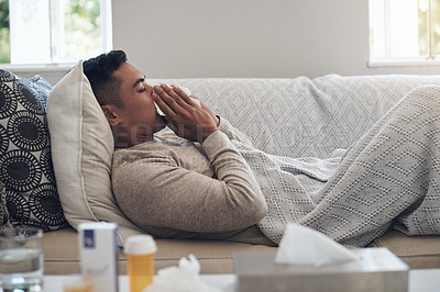 Buy stock photo Sick, man and blowing nose with tissue for flu, sinus or illness on living room sofa at home. Tired male person with paper or medication for sneeze, fever or influenza and infection on couch at house