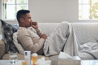 Buy stock photo Sick, man and cough with medication for flu, sinus or illness on living room sofa at home. Tired male person lying on lounge couch with fever, influenza or throat infection from bacteria at the house