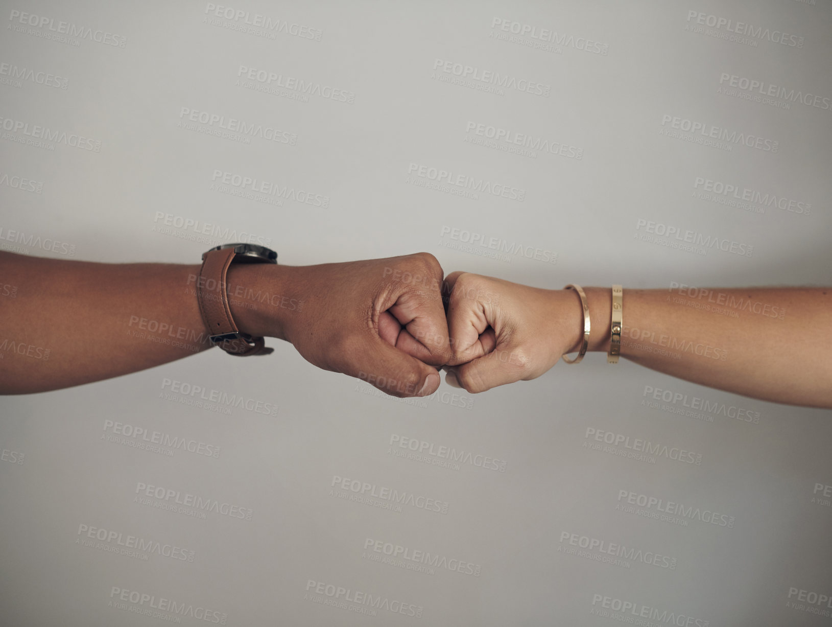 Buy stock photo Fist bump, hands and people in studio for celebration, support or partnership with victory. Jewelry, goal and closeup of couple with team building, love and connection isolated by gray background.