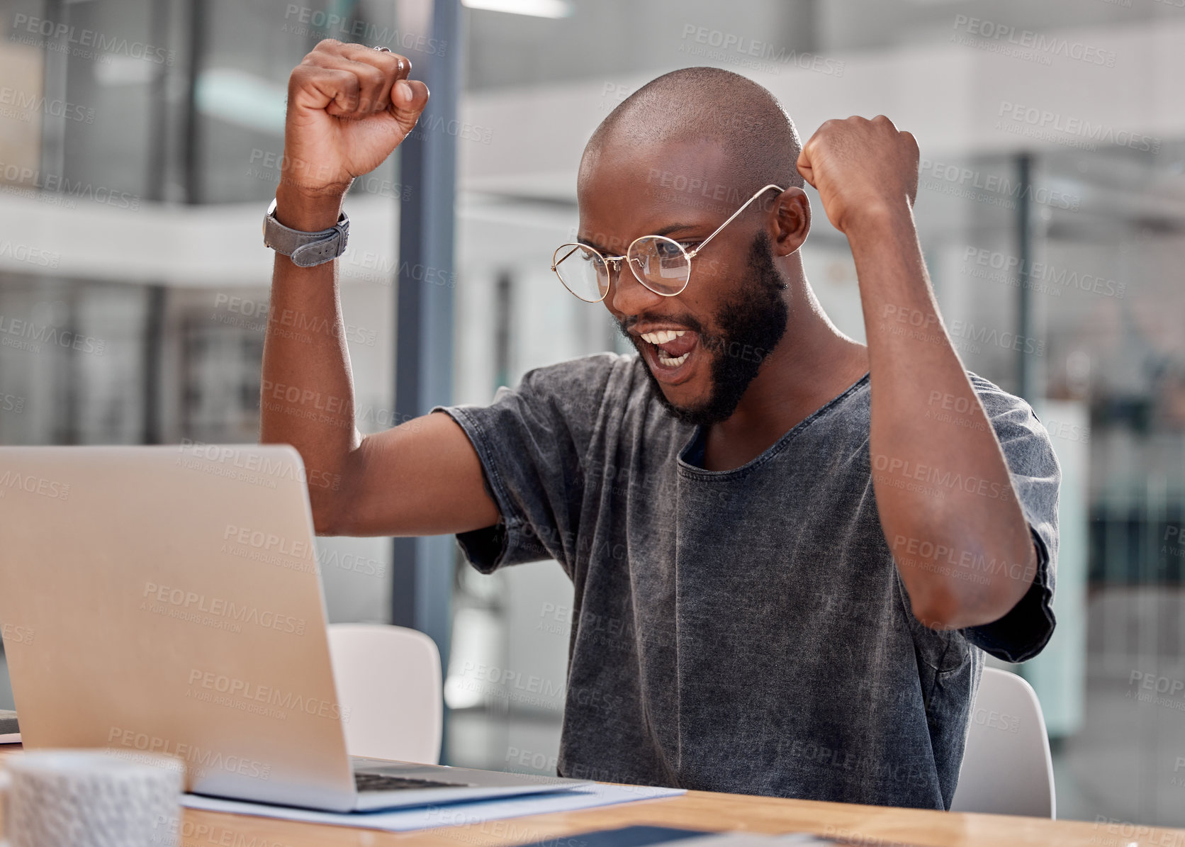 Buy stock photo Shot of a young businessman using a laptop at the office