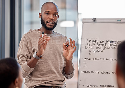 Buy stock photo Shot of a young businessman making a presentation at the office