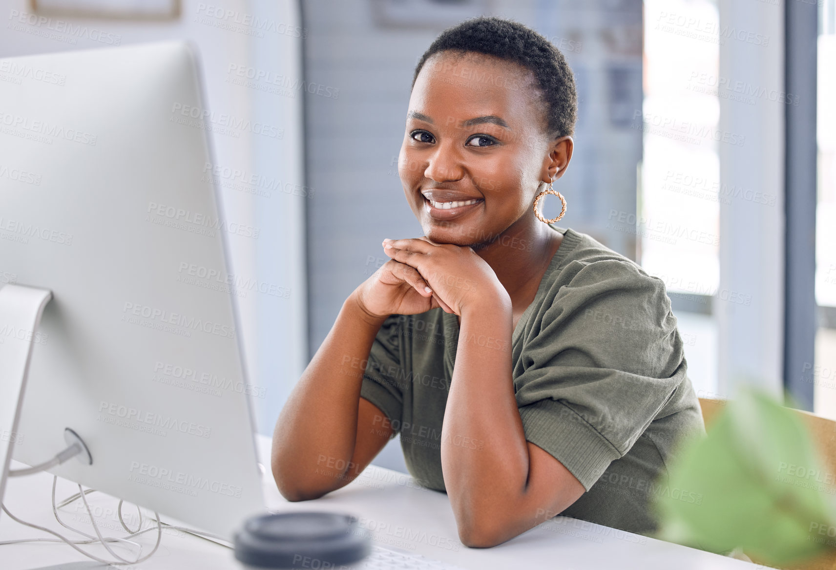 Buy stock photo Portrait of a businesswoman smiling while sitting at her desk