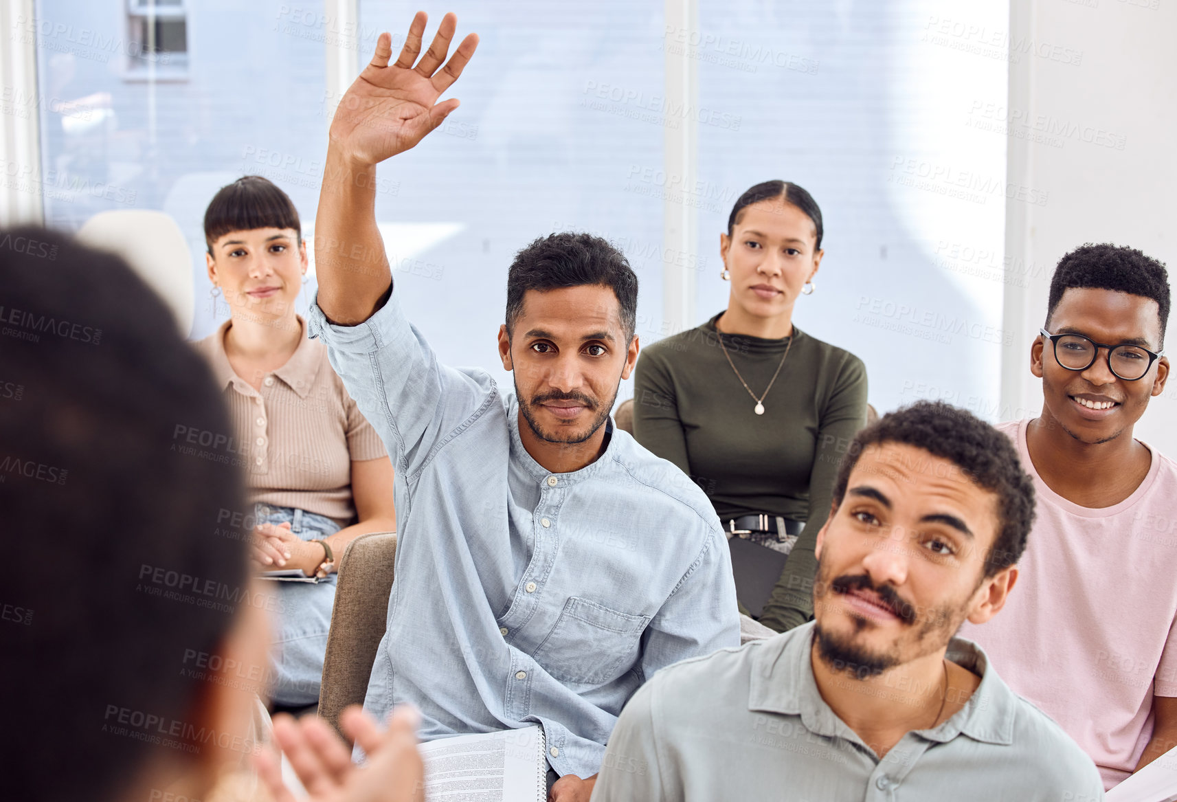 Buy stock photo Shot of a young businessman raising his hand during a presentation in an office
