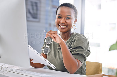 Buy stock photo Portrait of a businesswoman smiling while sitting at her desk