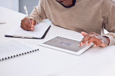 Buy stock photo Cropped shot of a businessman using a digital tablet while filling in some paperwork