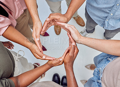 Buy stock photo Closeup shot of a group of unrecognisable businesspeople forming a circle with their hands
