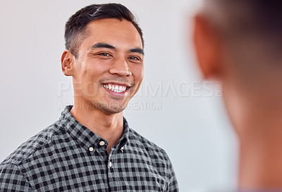 Buy stock photo Shot of a young businessman smiling in an office