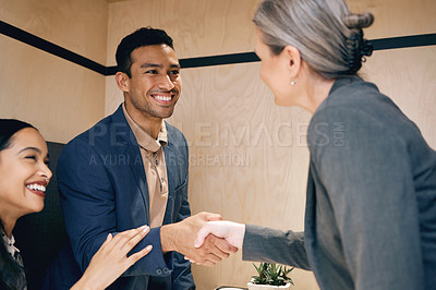 Buy stock photo Cropped shot of an affectionate young couple meeting with their mature female financial advisor