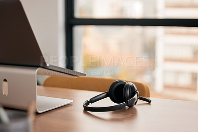 Buy stock photo Still life shot of a wireless headset on a desk in a call center