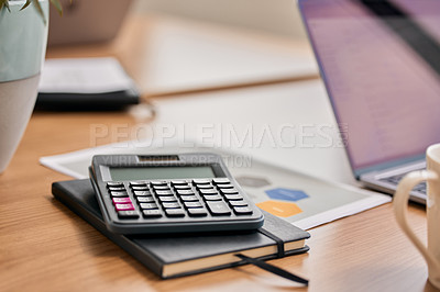 Buy stock photo Still life shot of a calculator and notebook on a desk in an office