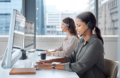Buy stock photo Shot of two female customer care workers in their office