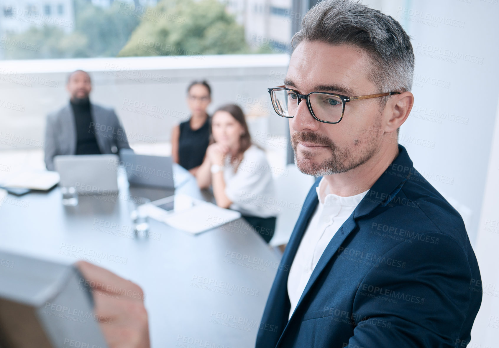 Buy stock photo Shot of a mature businessman using a whiteboard during a presentation in an office