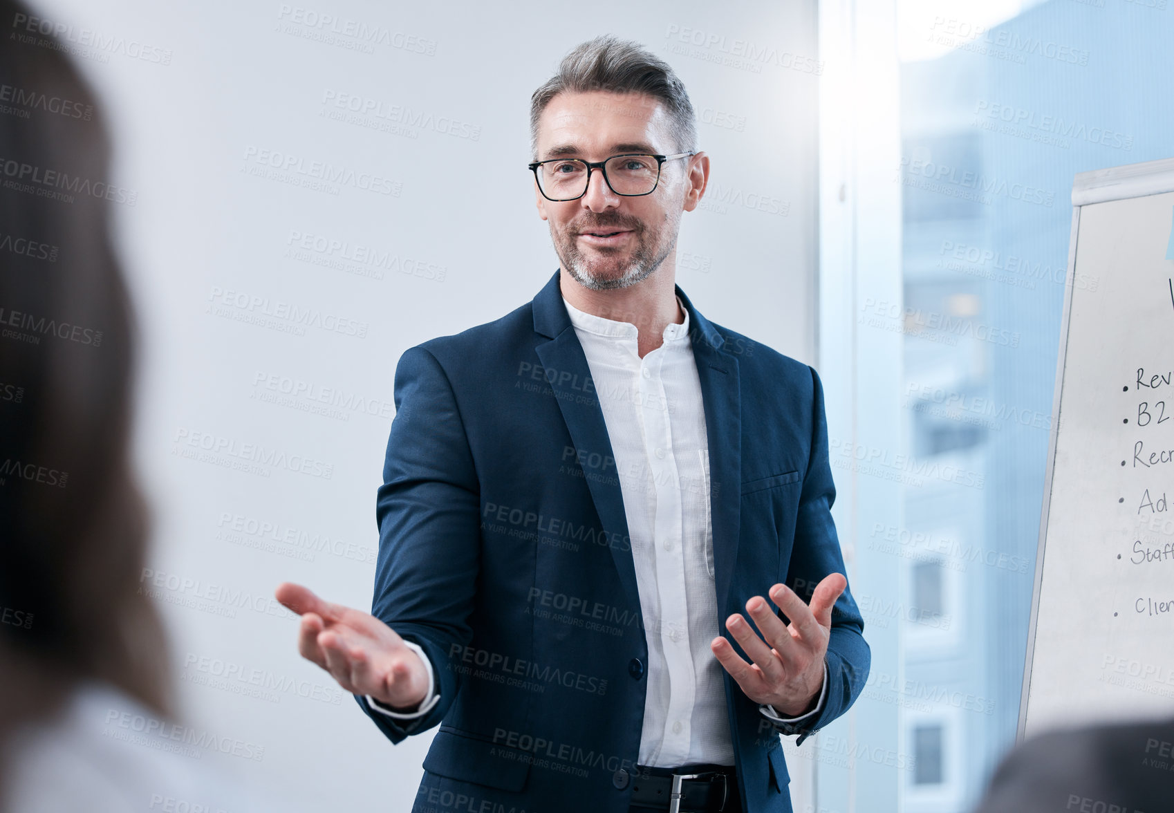 Buy stock photo Shot of a mature businessman giving a presentation to his colleagues in an office