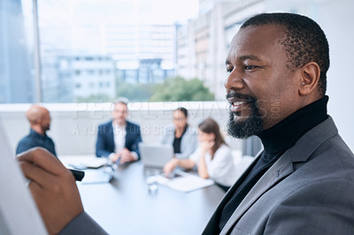 Buy stock photo Shot of a mature businessman using a whiteboard during a presentation in an office