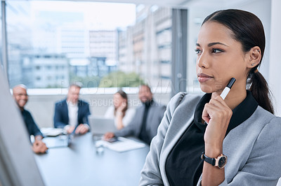 Buy stock photo Shot of a young businesswoman looking thoughtful in an office during a presentation in an office
