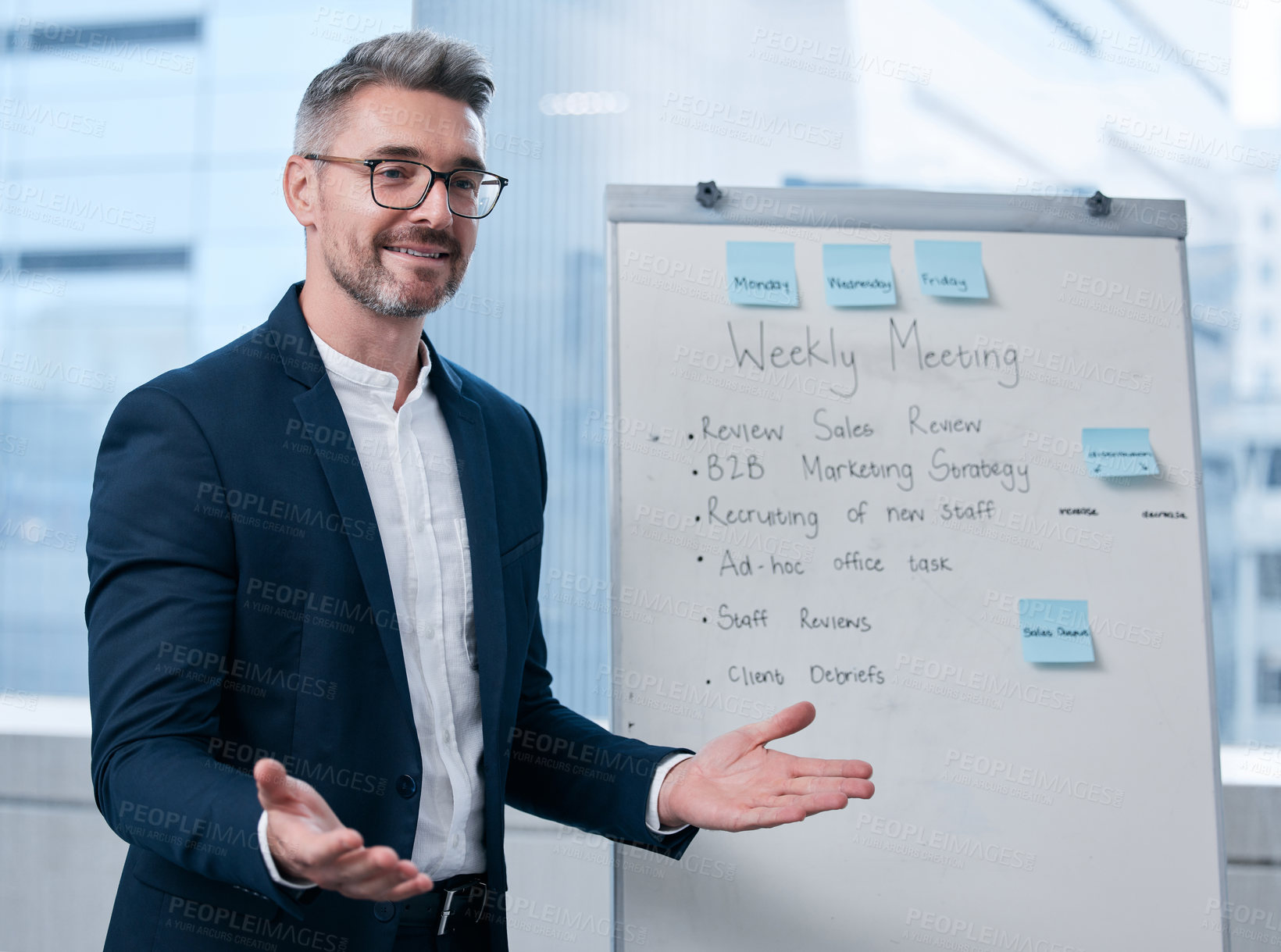 Buy stock photo Shot of a mature businessman using a whiteboard during a presentation in an office