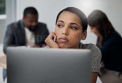 Buy stock photo Shot of a young businesswoman looking bored at her desk