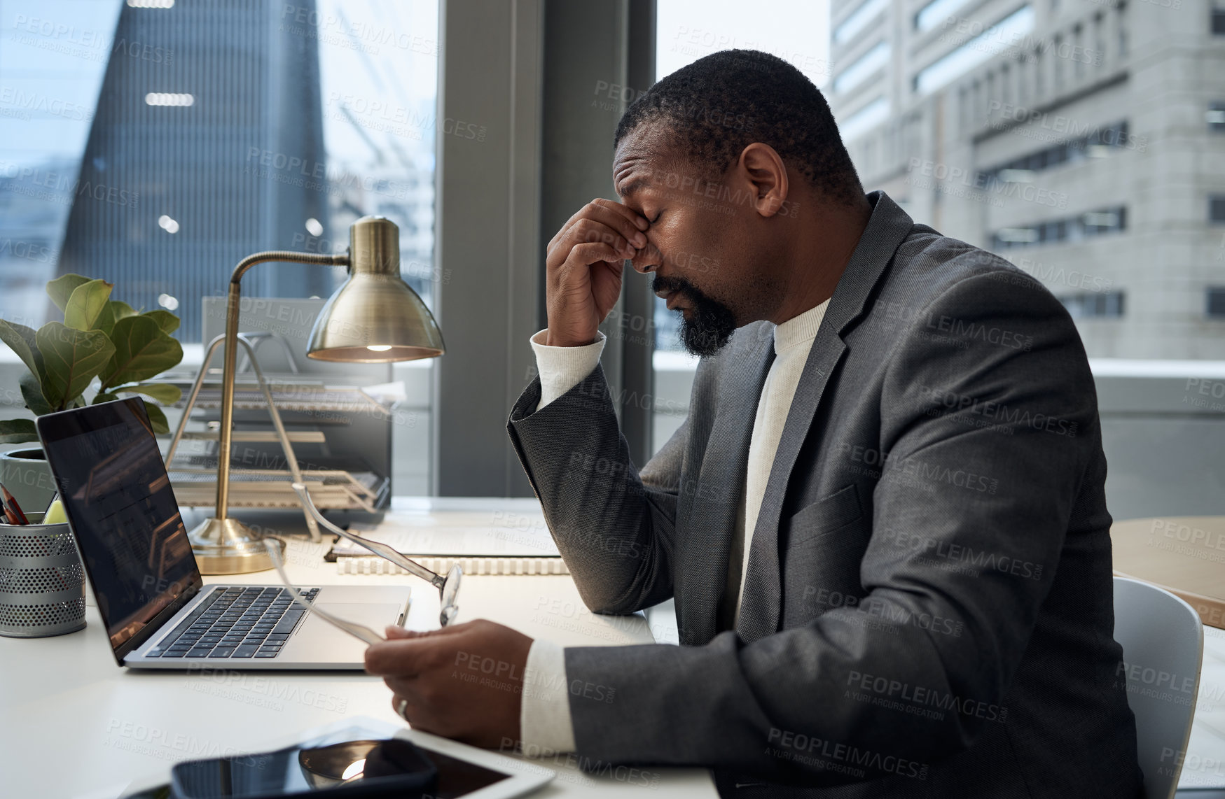 Buy stock photo Businessman, stress and headache by laptop with tension for burnout, pressure and overworked. Office, migraine and frustrated accountant with pain for audit deadline, problem and exhausted at desk