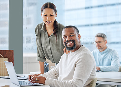 Buy stock photo Portrait of two businesspeople working together on a laptop in an office