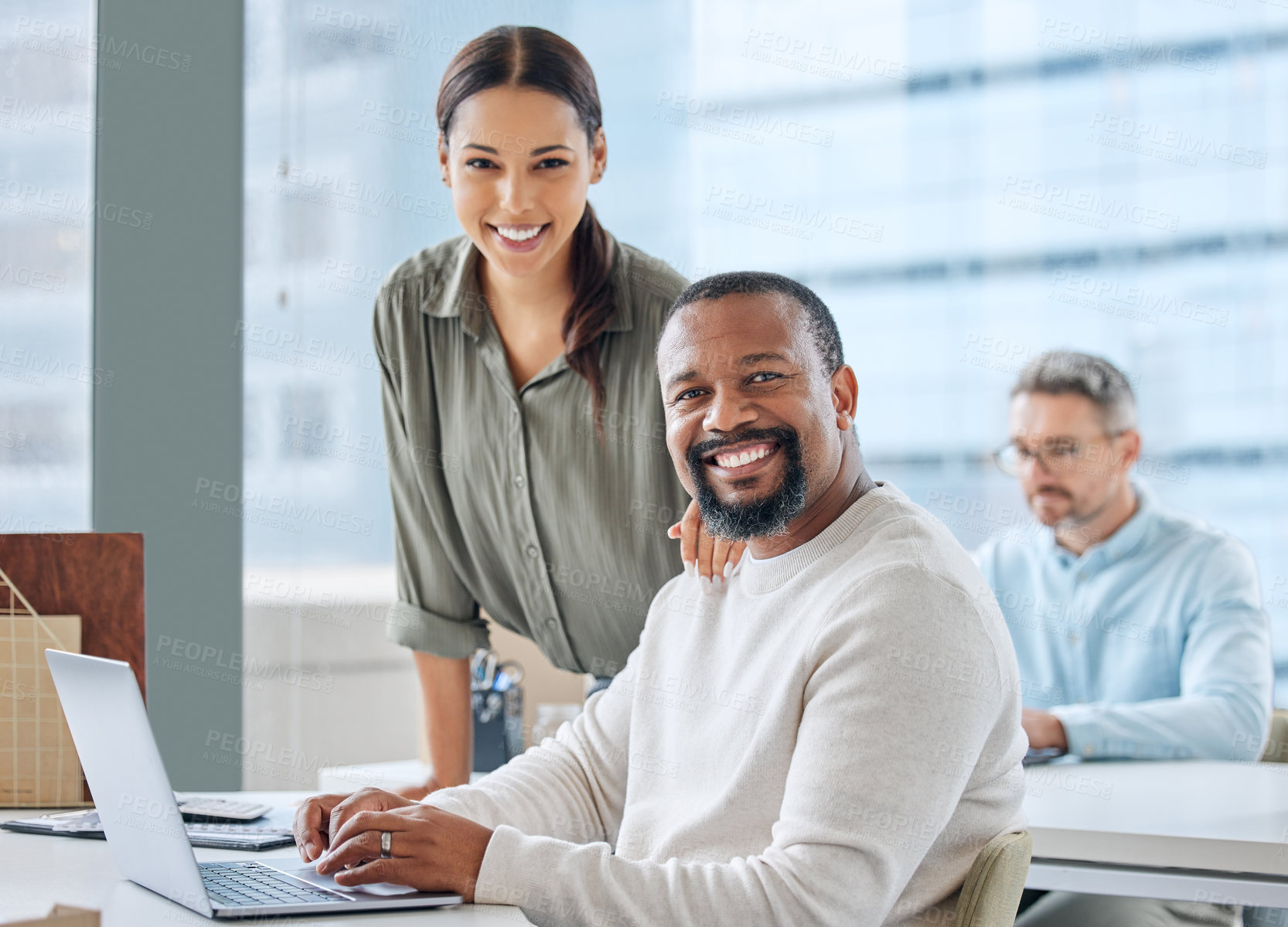 Buy stock photo Portrait of two businesspeople working together on a laptop in an office