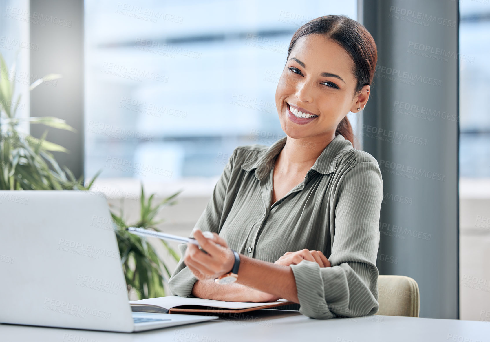 Buy stock photo Portrait of a young businesswoman working on a laptop in an office