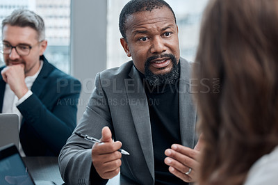 Buy stock photo Cropped shot of a group of corporate business colleagues having a meeting around the table in the boardroom