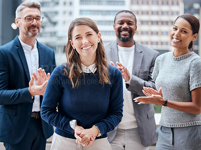 Buy stock photo Portrait of a young businesswoman being applauded by her team