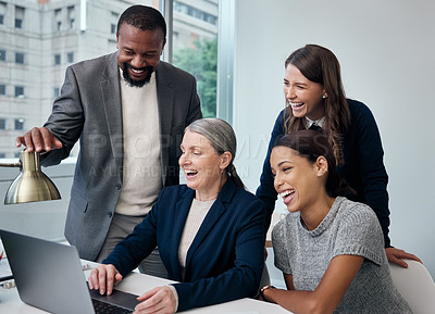Buy stock photo Shot of a group of businesspeople using a laptop at the office